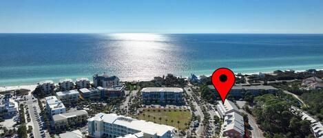 An aerial view of a coastal town with buildings, roads, and a beach.