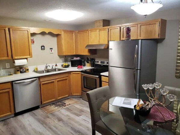 Enjoy cooking in this well-equipped kitchen with a dishwasher, microwave, and dining table.