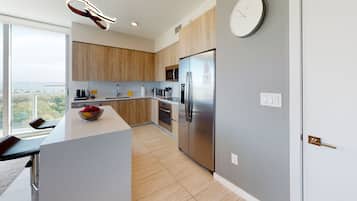 Panoramic Condo | Private kitchen | Full-size fridge, microwave, oven, stovetop