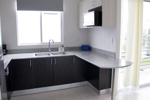 Fridge, microwave, stovetop, coffee/tea maker