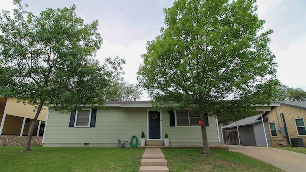 A two-story house with a front yard, a front door, and a visible staircase leading to the entrance. - Lemon Drop- A refreshing stop (Sonora)