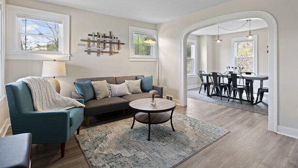 A living room with a sofa, armchair, round coffee table, and dining area with chairs and a table. - Family and dog friendly☆3BR house☆Porch swing☆Mars☆PGH☆Cranberry (Mars)