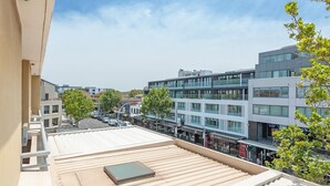 A rooftop terrace with a skylight, overlooking a street with modern buildings and shops. - Cremorne - MP303 Military Road - Convenient Studio in the Heart of Cremorne with Shops, Dining Transport at Doorstep (Cremorne)