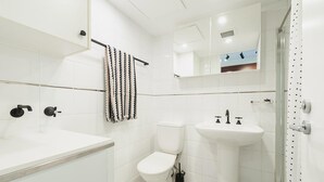 A modern bathroom with a white sink, toilet, and shower. - Cremorne - MP303 Military Road - Convenient Studio in the Heart of Cremorne with Shops, Dining Transport at Doorstep (Cremorne)