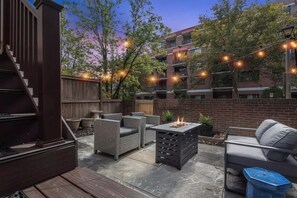 Relax on the patio with comfortable wicker furniture and a cozy fire feature.