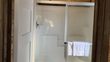 Shower, hair dryer, towels, toilet paper