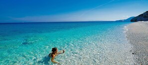 A beach with clear turquoise water and a rocky shoreline. - Casa Il Cactus - Two-room apartment with large terrace overlooking the sea (Portoferraio)