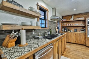 Enjoy cooking in this well-equipped kitchen with a central island and ample counter space.