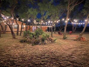 Escape to a serene outdoor oasis with a charming wooden building and lush surroundings.