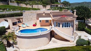 A Mediterranean-style villa with a swimming pool, a covered patio, and a view of the surrounding hills. - Castellons Vida by Interhome (Moraira)