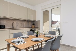 A modern kitchen with a dining area.