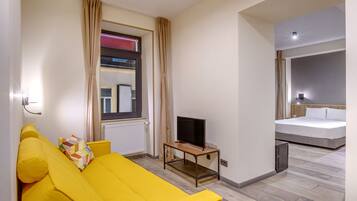 Superior Suite | Living area | 100-inch LCD TV with cable channels, TV
