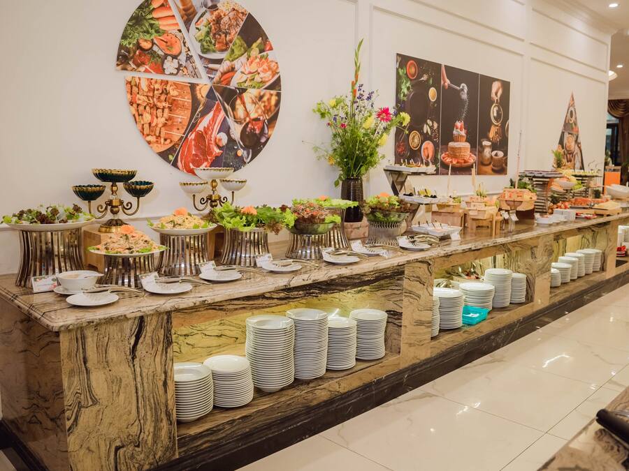 A buffet setup with various food items and dishes.