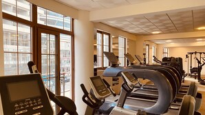 A gym with treadmills, exercise bikes, and weight machines.