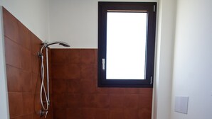 A bathroom with a shower, toilet, and a window. - Double Room 1 - Disabled (Pizzolungo)