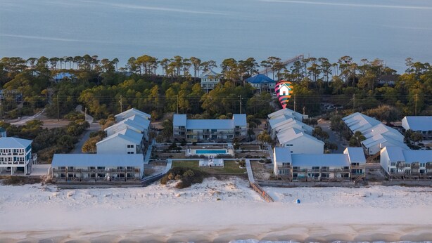 A coastal resort with beachfront villas, a swimming pool, and a view of the ocean. - 300 Ocean Mile: 150 Steps to Beach! Kid Friendly, 2 Pools, Bikes! (Saint George Island)