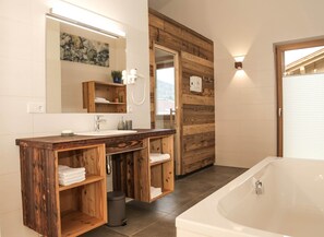 Bathtub, hair dryer, towels, soap