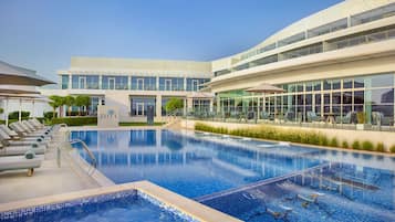 Outdoor pool, pool loungers, lifeguards on site