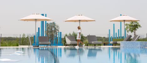 Outdoor pool, pool loungers, lifeguards on site