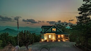 A two-story house with a porch and a flagpole in front. - High View Heights stunning views and complete privacy (Bryson City)