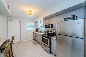 Enjoy cooking in this well-equipped kitchen with stainless steel appliances, a dining area, and plenty of natural light.