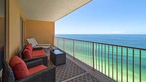 A balcony with wicker furniture and a view of the ocean. - 1906-19th Floor-PET FRIENDLY-Amazing Gulf View!-BEACH CHAIRS UMBRELLA INCL (Panama City Beach)