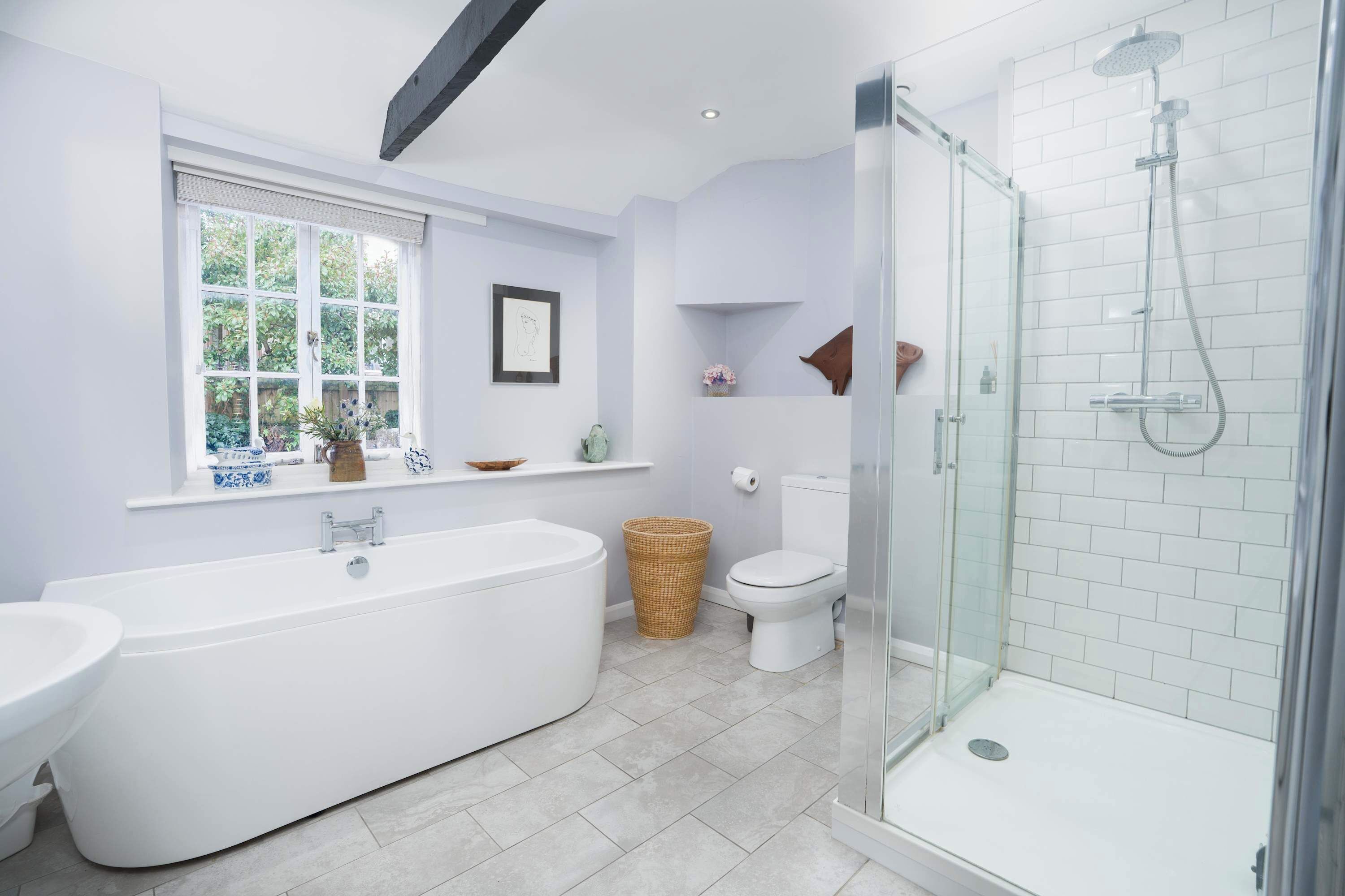 Bathtub, hair dryer, towels, shampoo