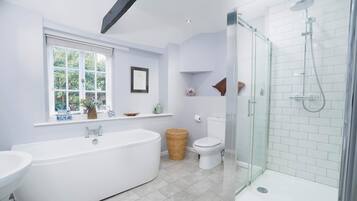 Bathtub, hair dryer, towels, shampoo