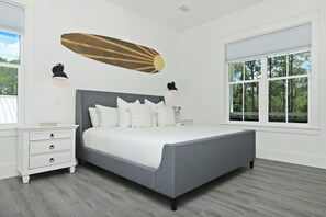 A bedroom with a large bed, two bedside tables, a dresser, and a window with a view of trees. - Private Pool | Walk to Seaside, WaterColor | 2 Masters- Sonshine by the Sea (Santa Rosa Beach)
