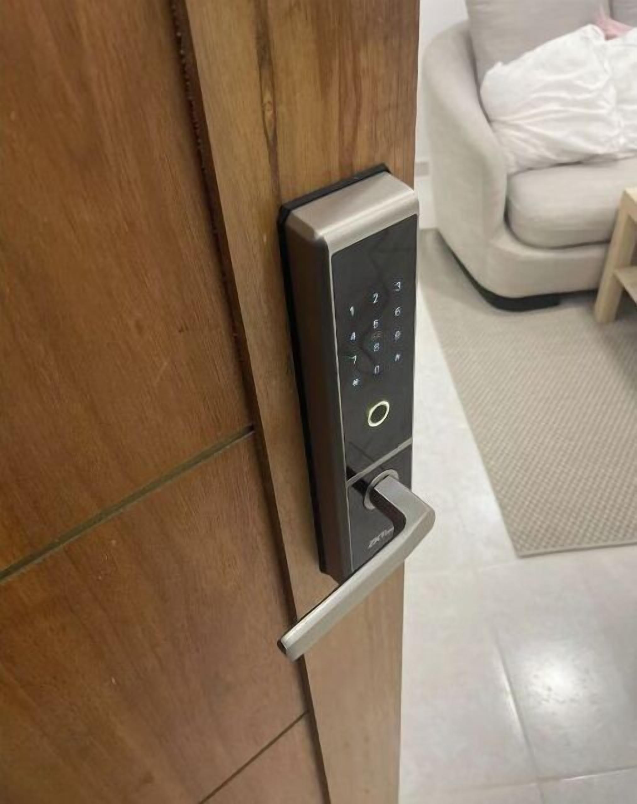 A modern door with a keypad lock and a push bar.