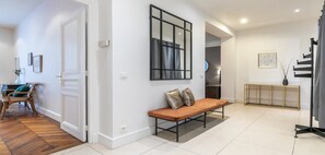 Relax in a serene space with a bench, mirror, and natural touches.