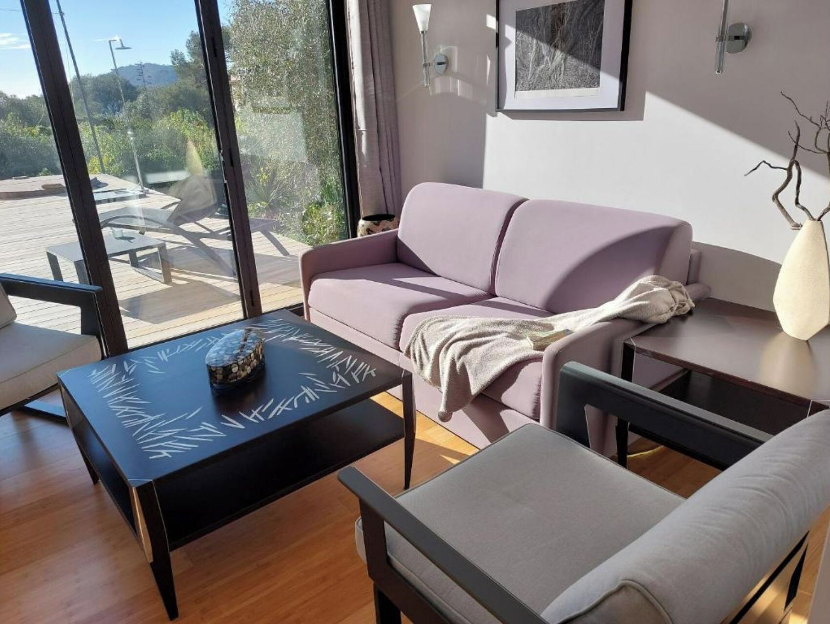 A modern living room with a sofa, a coffee table, and a chair.