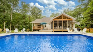 A house with a swimming pool, surrounded by trees. - (2027 OPEN!) Gorgeous Grand Beach Home With Private Pool! (Grand Beach)
