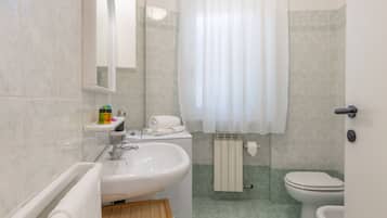 A bathroom with a sink, toilet, and shower.