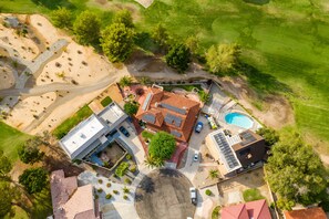 Enjoy leisure activities in the spacious backyard with a swimming pool and well-maintained lawn.