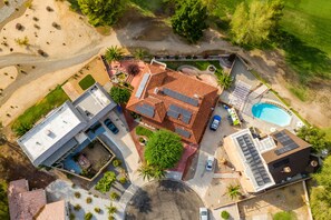 Enjoy a spacious backyard with a pool, patio, and lawn, perfect for relaxation and leisure activities.
