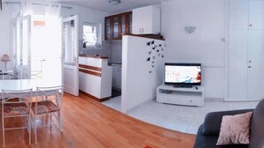 A modern living room with a sofa, TV, dining table, and chairs. - 3 minutes to the Diocletian's Palace! Two bedroom cosy apartment (Split)