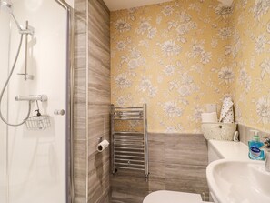 A bathroom with a shower, toilet, and sink. - The Dairy (Bakewell)
