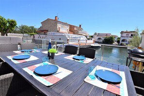 Enjoy meals with a scenic view from this dining area overlooking a body of water.