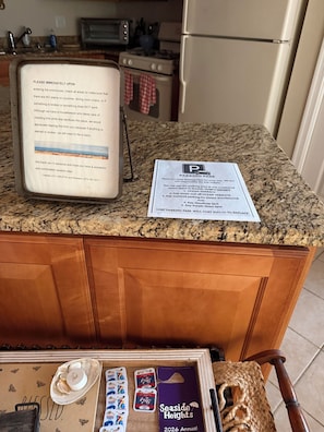 A kitchen counter with a parking pass and a message about checking for stains or damage.