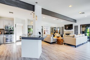 Enjoy a spacious open-plan living area with a kitchen and comfortable seating.