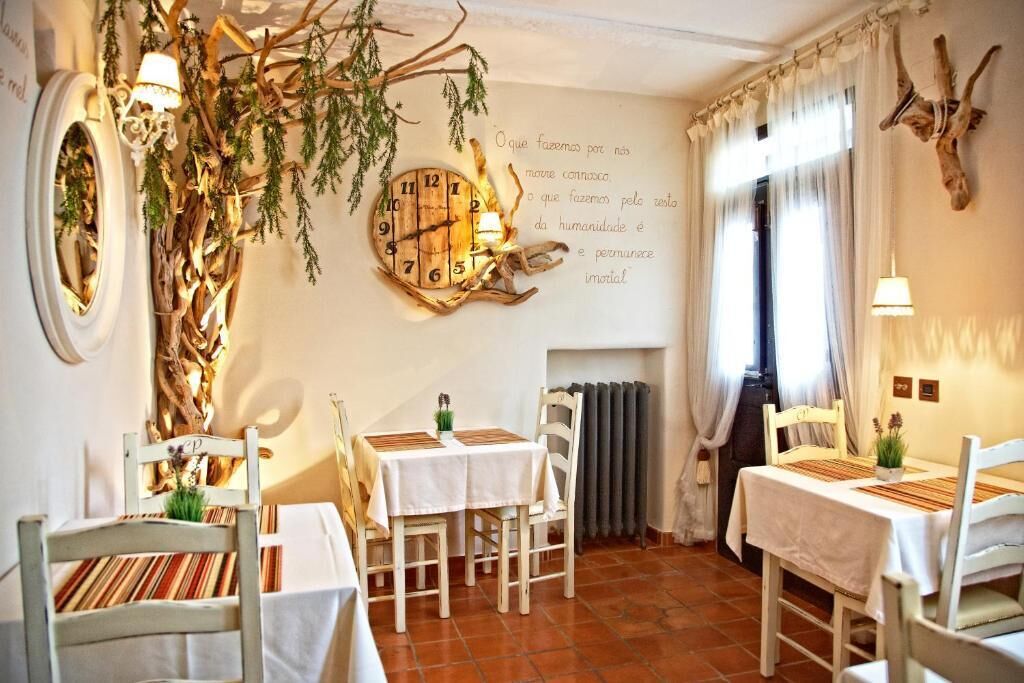 A cozy dining area with rustic decor, including a wall clock and a fireplace.