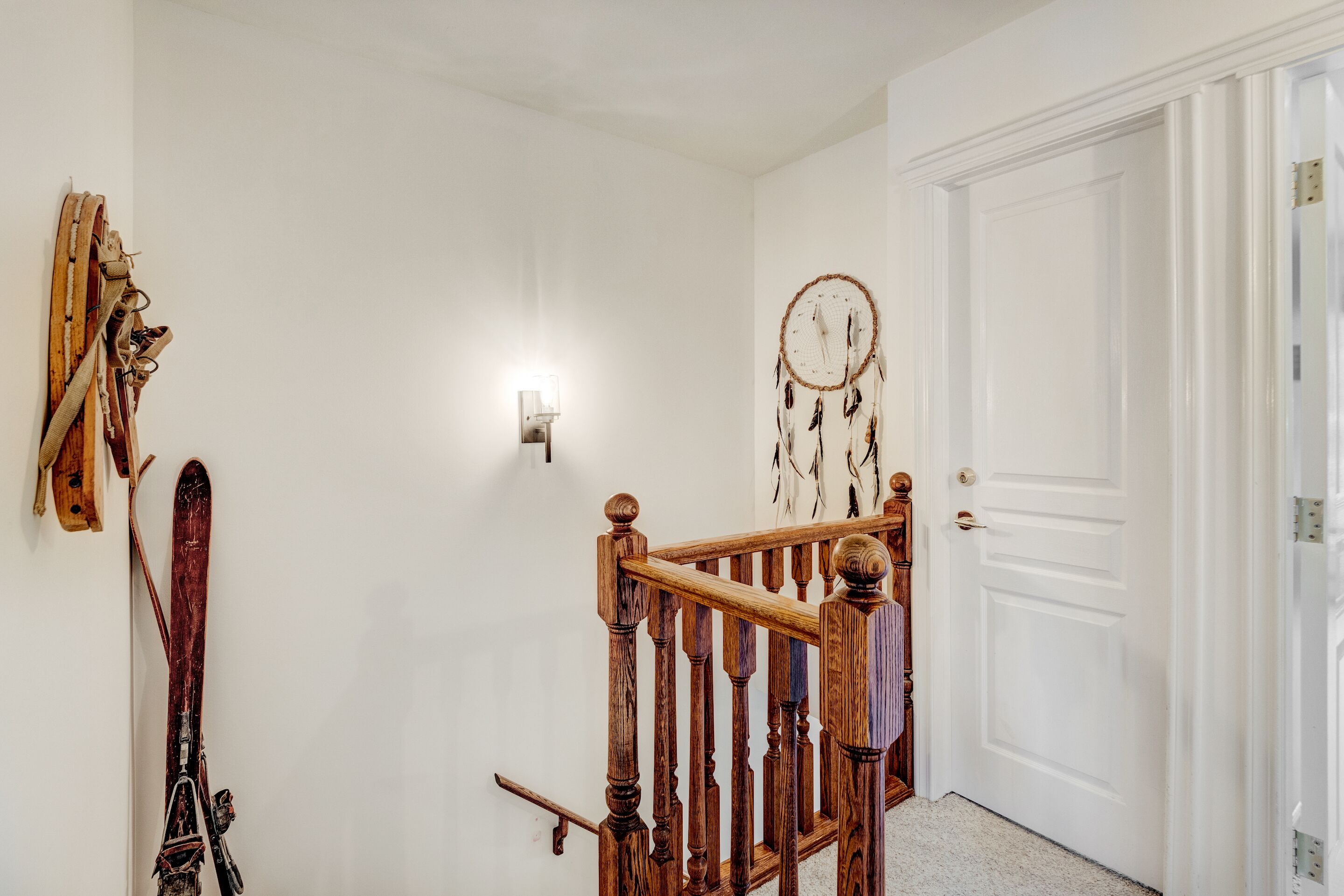 A staircase with wooden balusters and a white door.
