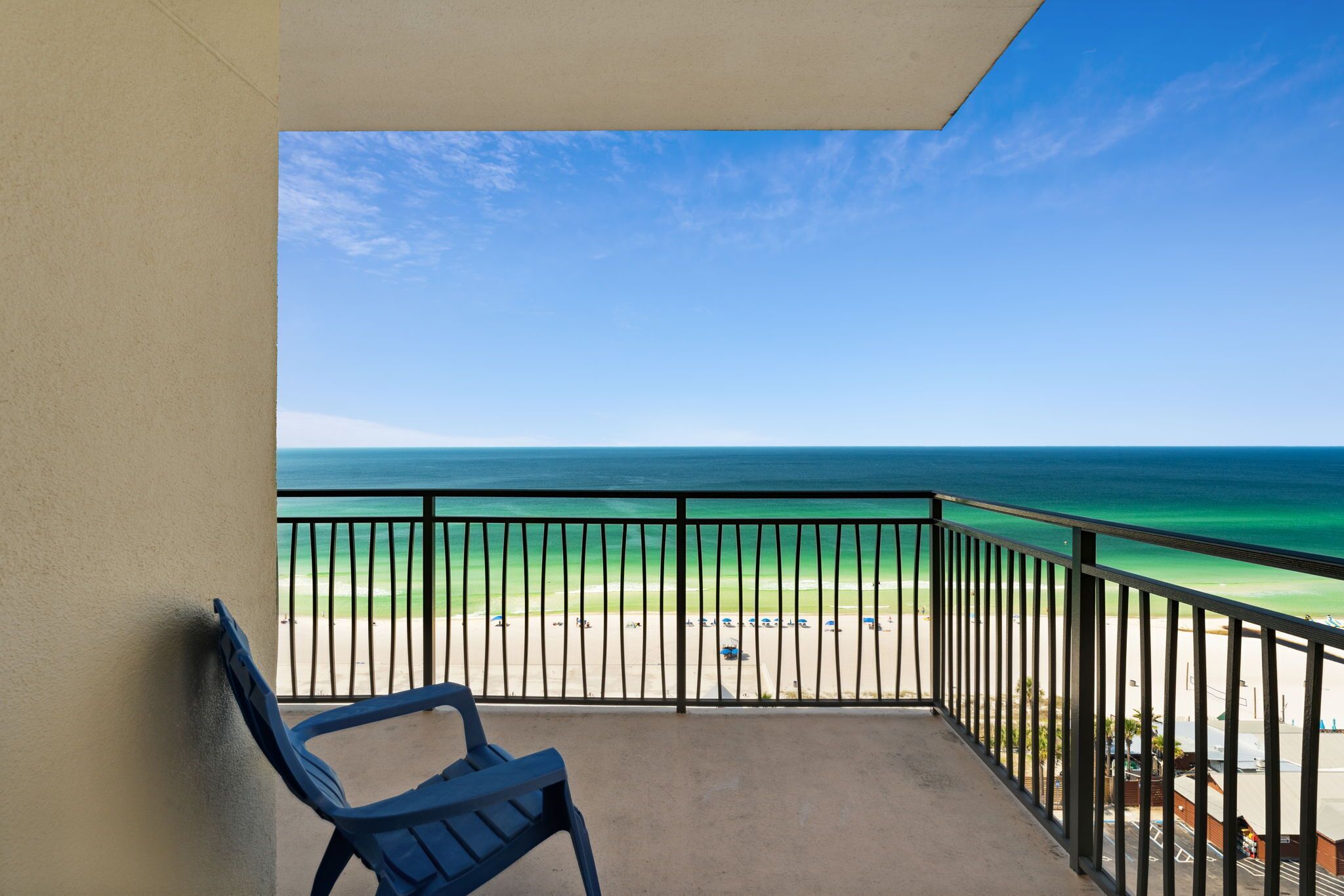 A balcony with a view of a beach and ocean.