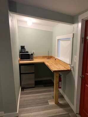 Enjoy a fully equipped kitchenette with a microwave, coffee maker, and refrigerator, plus a window with an outside view.