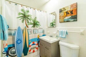 Bathtub, hair dryer, towels, shampoo
