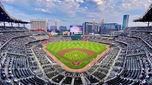 A large stadium with multiple tiers of seating, a central field, and surrounding modern buildings. - Cozy Riverfront Retreat Close to City (Mableton)