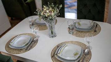 A formal dining experience awaits, with a beautifully set table for four.