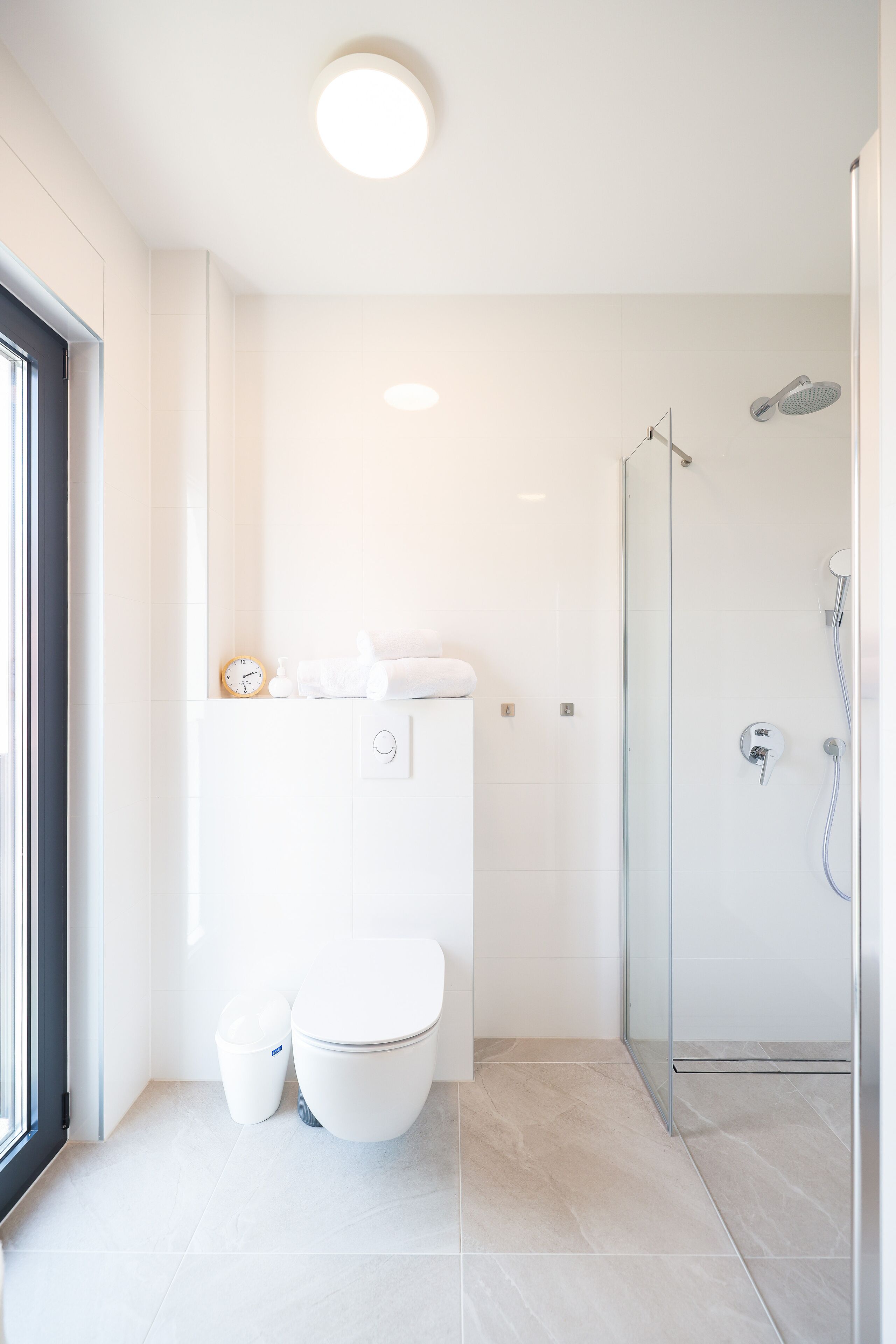 A modern bathroom with a toilet, bidet, and shower.