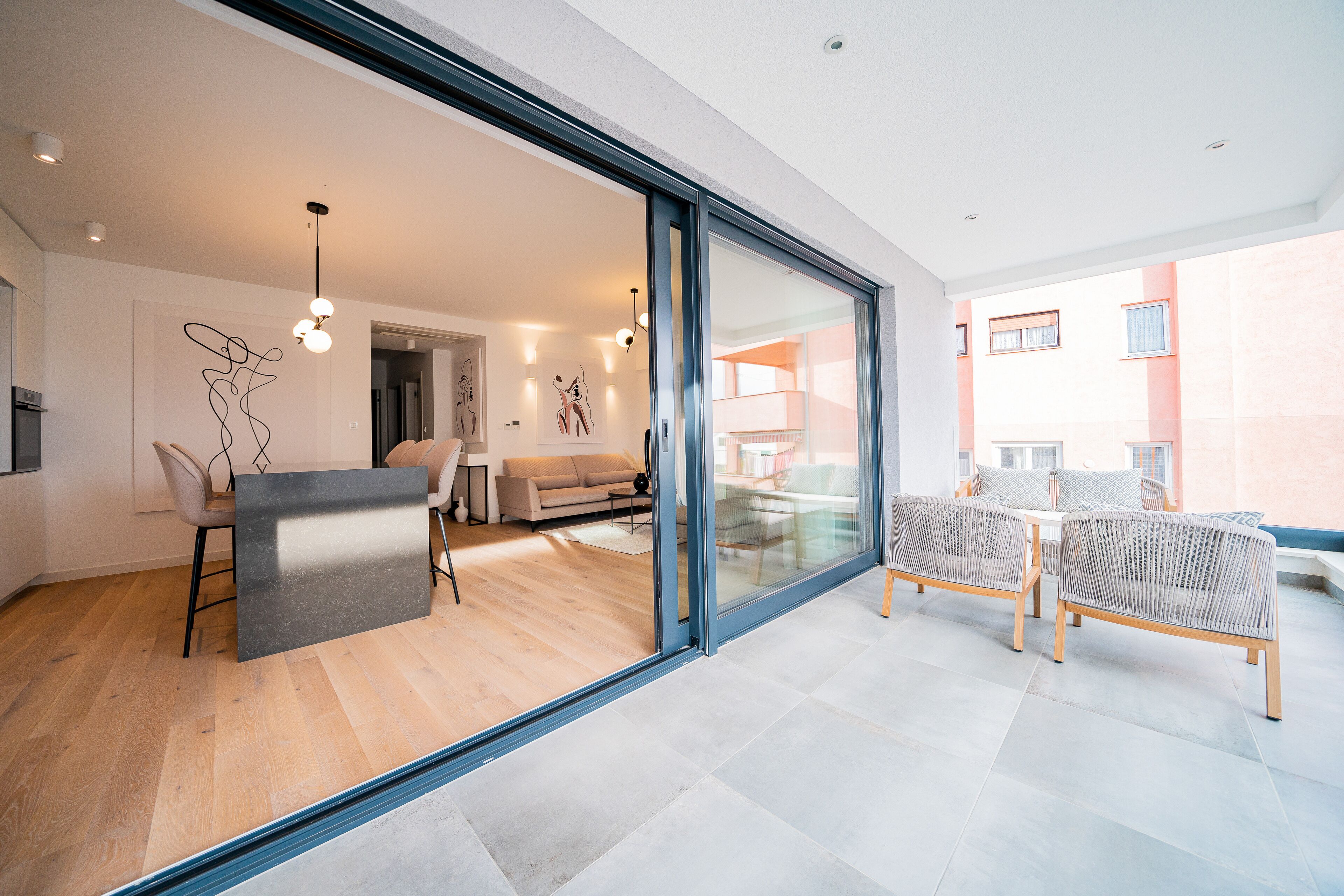 A modern interior with a dining area, kitchen, and living space.